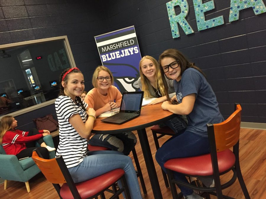 Freshman Bria Marlin, Haley Barker, Kenzie Sharp, and Lilliegh Rahmoeller are in the school library working on their homework.