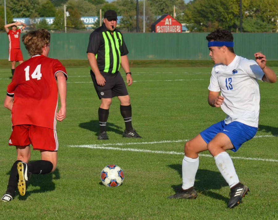 Cole Hartman, defending for the Jays against a New Covenant player 