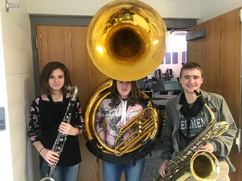 Alex, and some friends pose for a picture with their instruments.