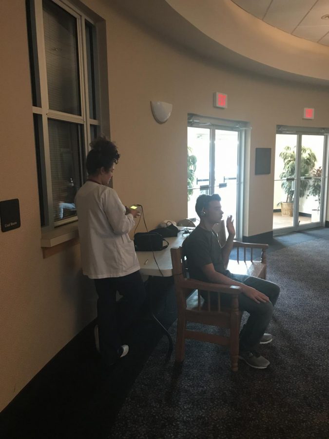 Freshman students getting his hearing checked.